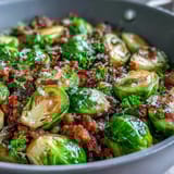 Garlic-infused Brussels sprouts and browned ground turkey mingle with paprika in a skillet, ready for a bright lemon squeeze.