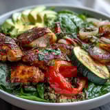 Bright paprika roasted vegetables and fluffy quinoa top this nourishing bowl, garnished with parsley and fresh lemon salad.