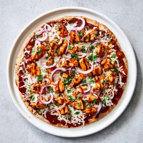 Freshly baked Chicken BBQ Pizza topped with tangy barbecue sauce, juicy grilled chicken slices, red onions, and melted mozzarella cheese.