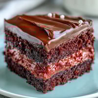 Freshly baked Red Betty Boop Heart Cake with vibrant red layers and a smooth cream cheese frosting slice ready to serve. 